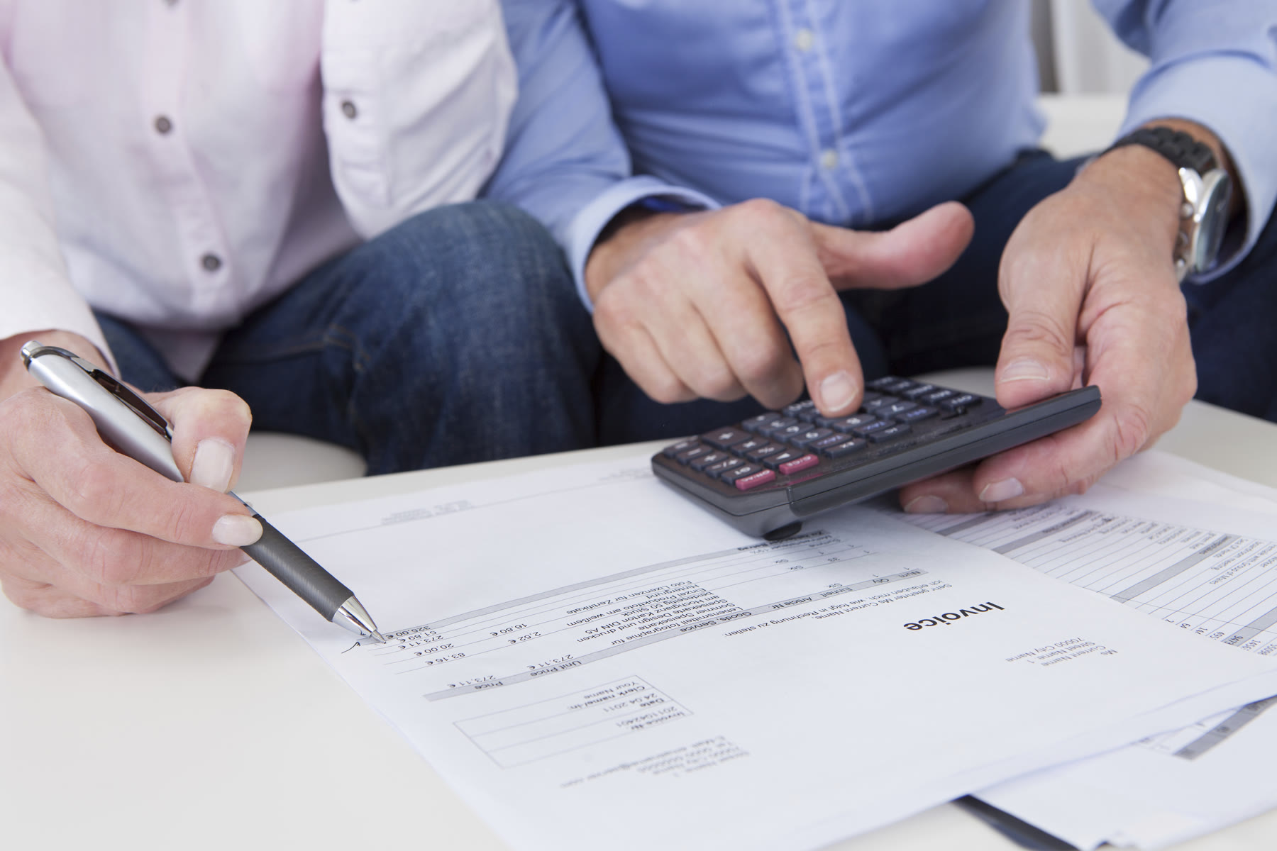 A couple reviewing finances with a calculator